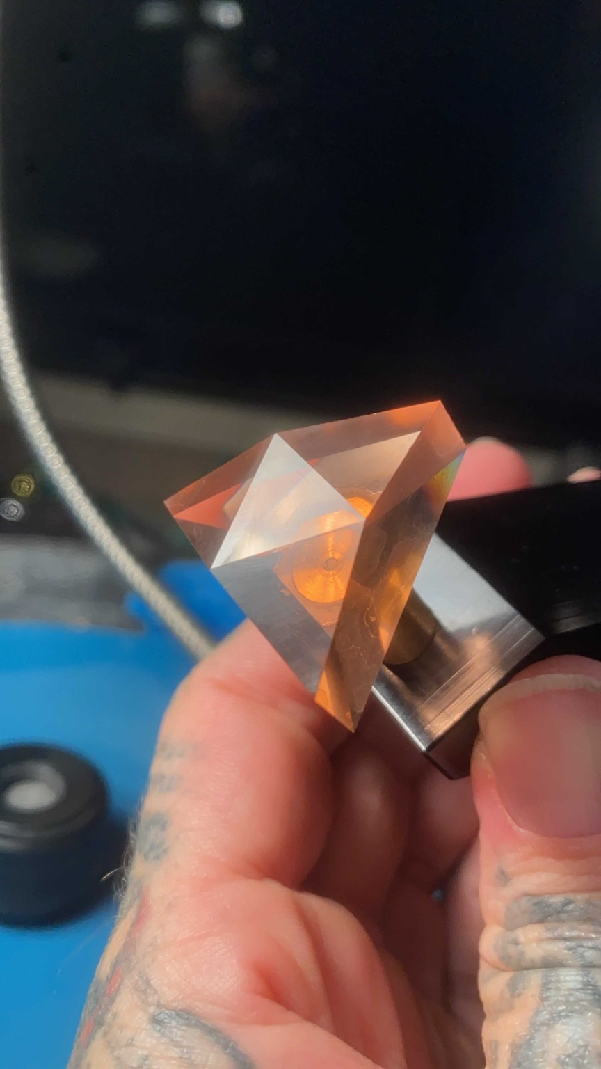 Artifact in fabrication: faceting process with tools and hand in frame
